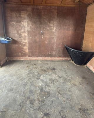 After: the same stable, empty